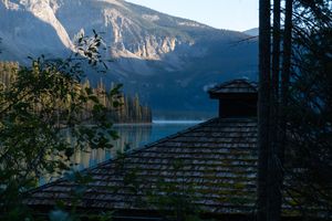 A zoomed in corner of a lodge in front of Emerald Lake, Yoho National Park, with morning mist covering the surface of the water.