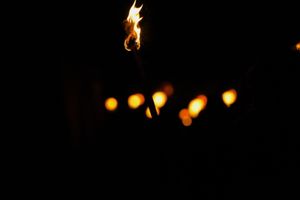 A lit torch ready to light the bonfire.